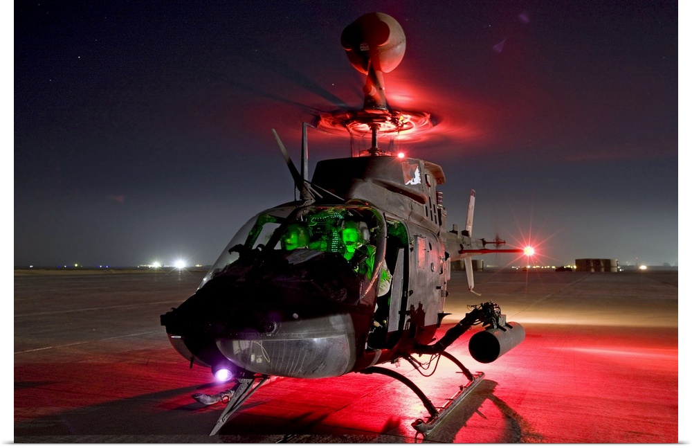 A helicopter is lit up as it gets ready to take off during the night.