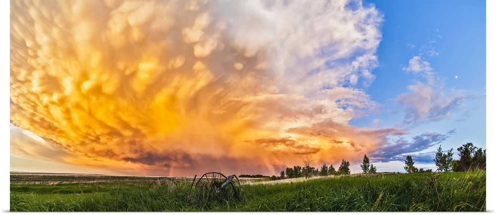 June 17, 2013 - Panoramic view of a retreating thunderstorm at sunset, Alberta, Canada. The storm shows mammatocumulus clo...