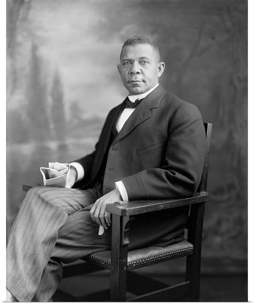 Portrait of Booker T. Washington sitting in a chair.