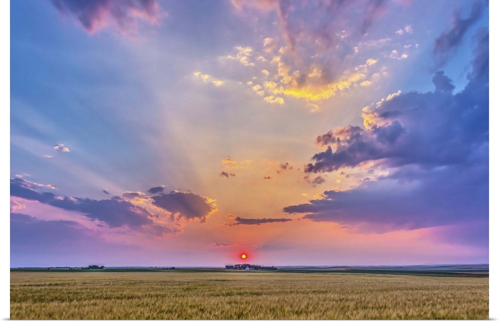 August 6, 2014 - High dynamic range photo of a red setting Sun in haze, casting shadows across the sky, crepuscular rays, ...