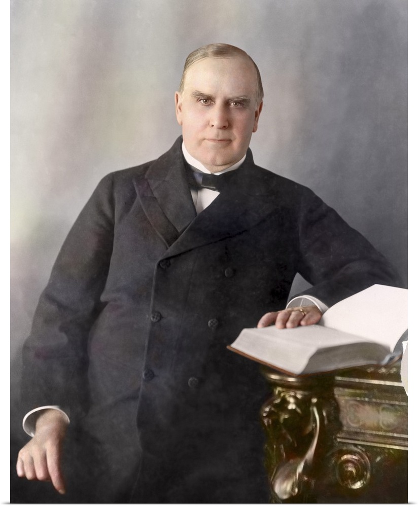 President William McKinley, half-length portrait, seated at desk, facing front, circa 1900.