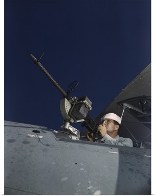 Sailor tries out a .30-caliber machine gun on a Navy plane at Naval Air Base, Texas