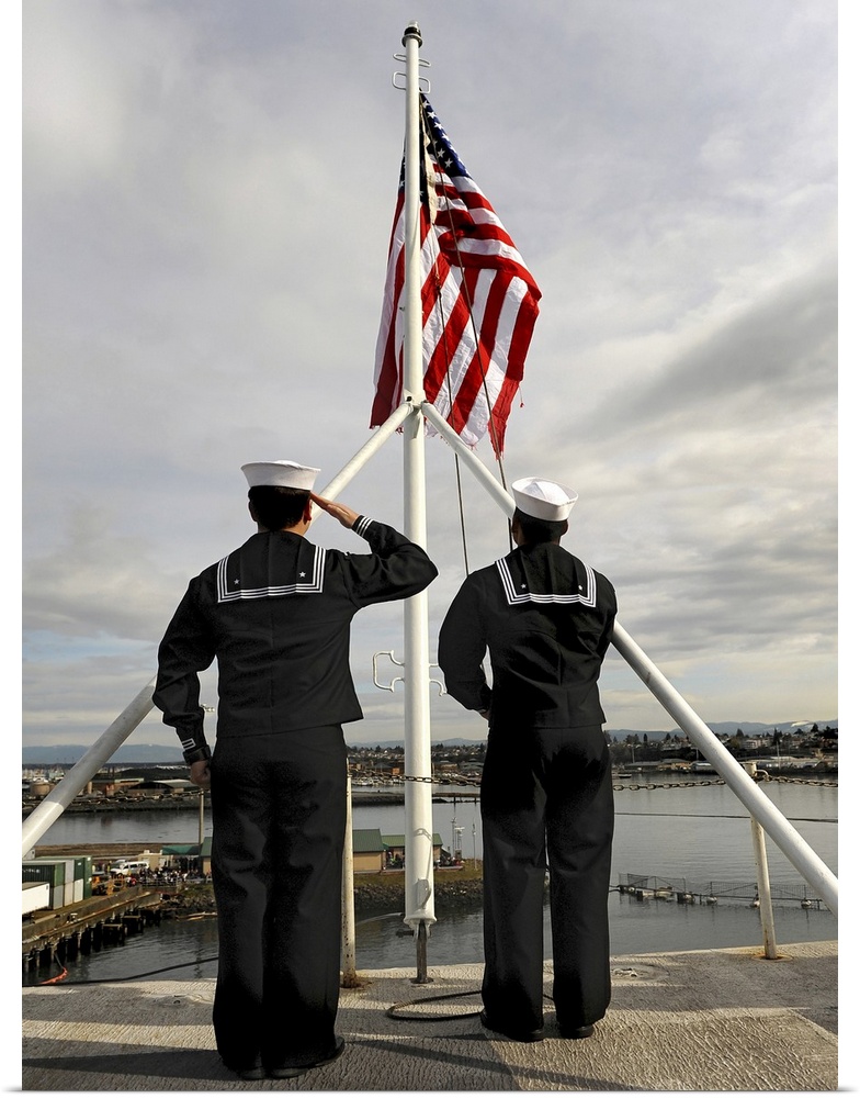 March 24, 2011 - Sailors aboard the aircraft carrier USS Abraham Lincoln (CVN-72) raise the national ensign as the ship mo...