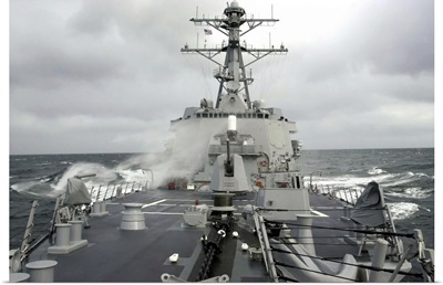Sea spray whips across the deck of the USS Winston S Churchill