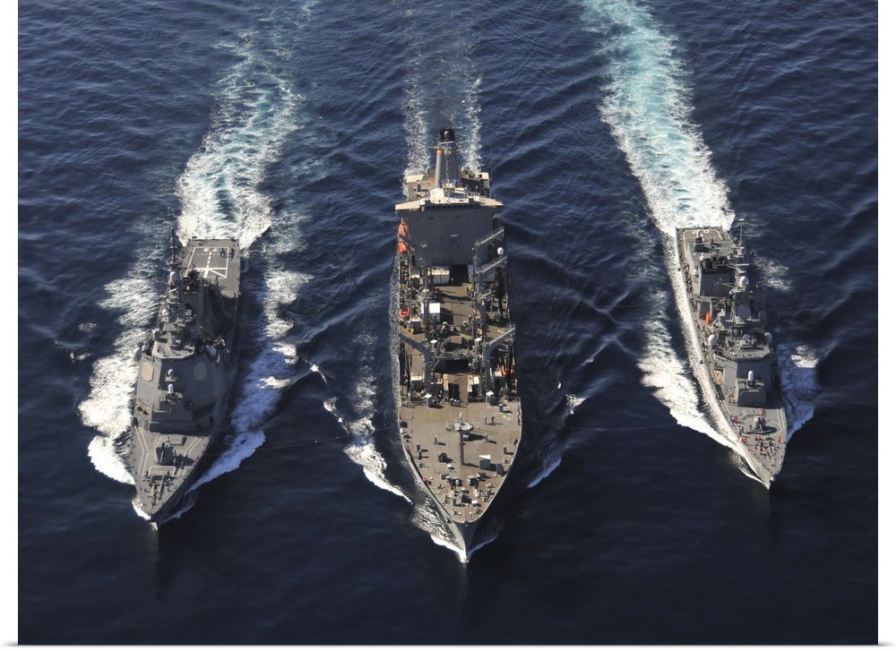 December 5, 2010 - The Military Sealift Command fleet replenishment oiler USNS Tippecanoe (T-AO 199), center, refuels the ...