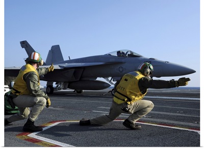 Shooters Aboard The USS George HW Bush Give The Signal To Launch An F/A-18 Super Hornet