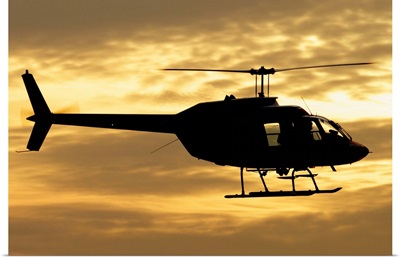 Silhouette of a Bell 206 utility helicopter