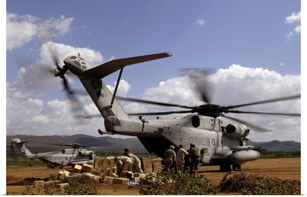 November 20, 2005 - Resident soldiers and sailors in Harar, Ethiopia, help pile boxes of food and water, which is being of...
