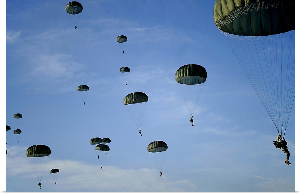 Soldiers descend under a parachute canopy during Operation Toy Drop.