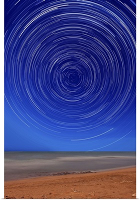 Star trails around the south celestial pole at the beach in Miramar, Argentina