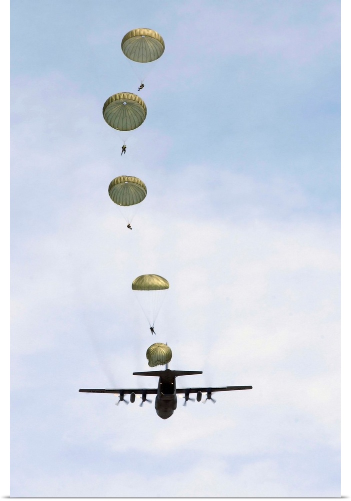 Students jump from a C-130 Hercules.