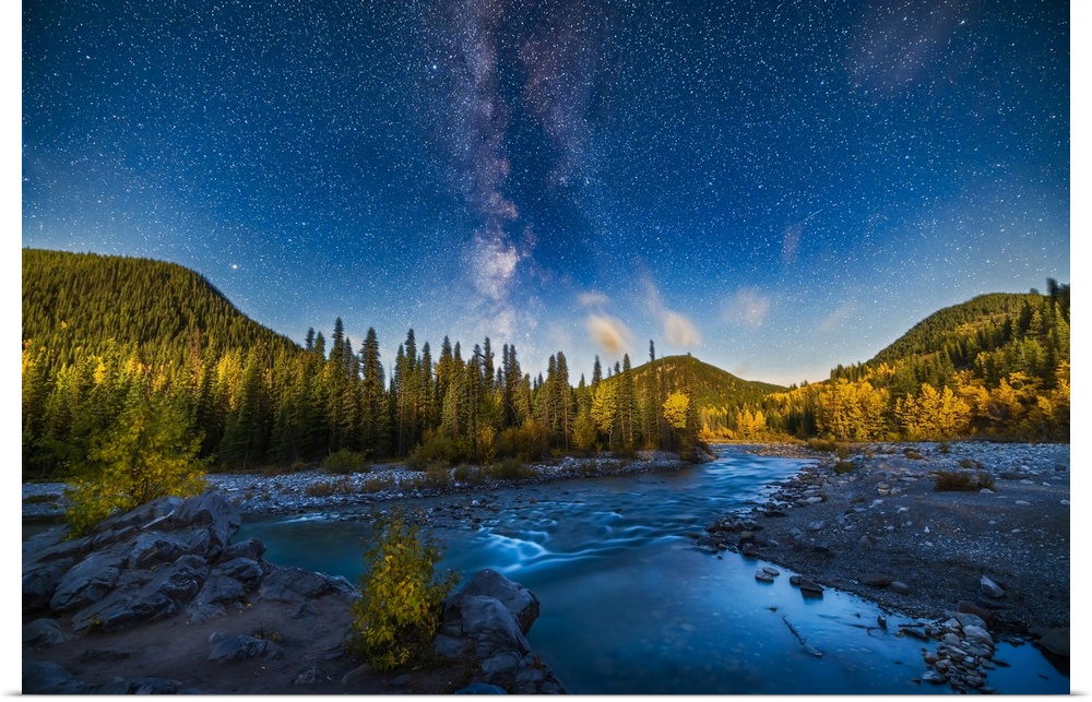 A nightscape scene of the summer Milky Way setting over the Elbow River in southern Alberta, Canada