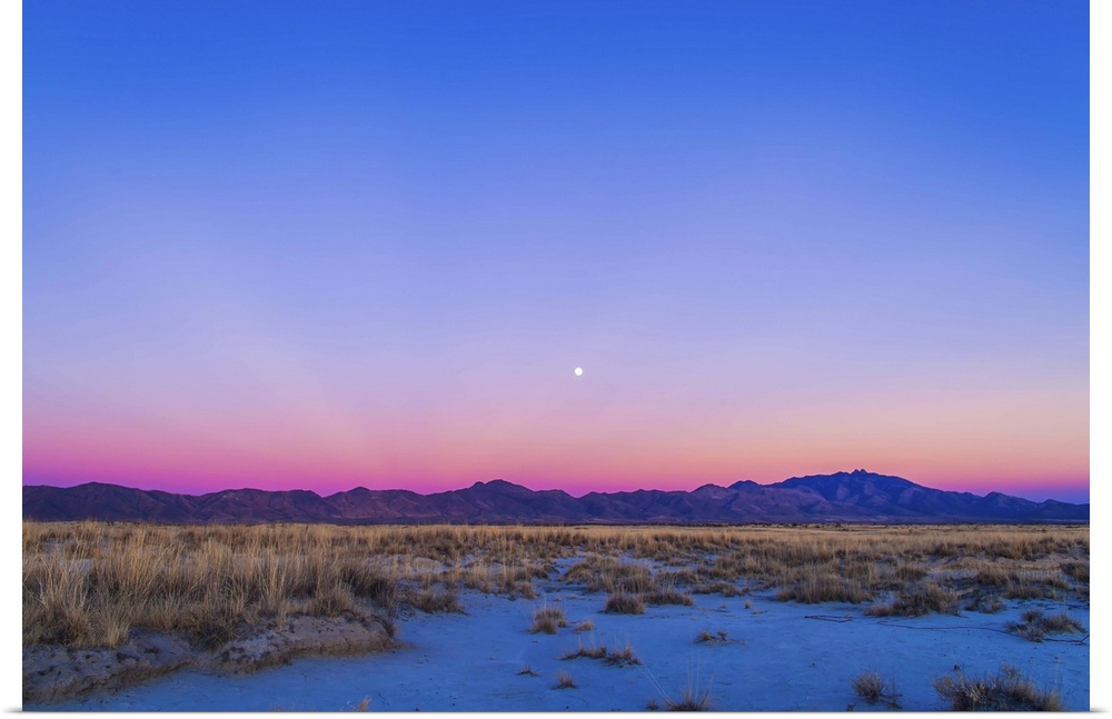 December 15, 2013 - Sunset twilight colors and the waxing gibbous moon over the Chiricahua Mountains in southeast Arizona,...