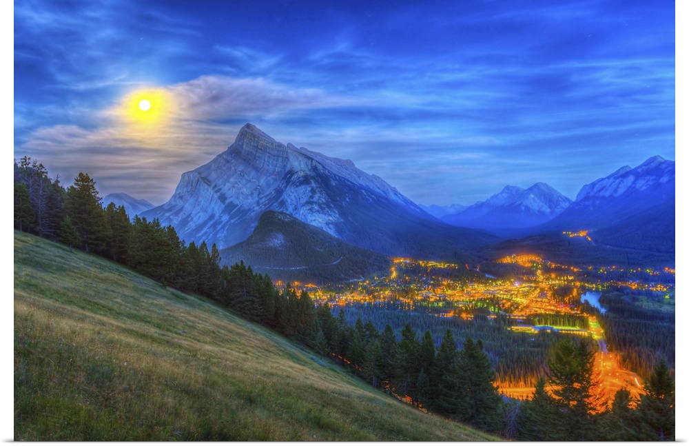 August 10, 2014 - High dynamic range photo of the supermoon rising behind Mt. Rundle and Banff townsite, as seen from the ...