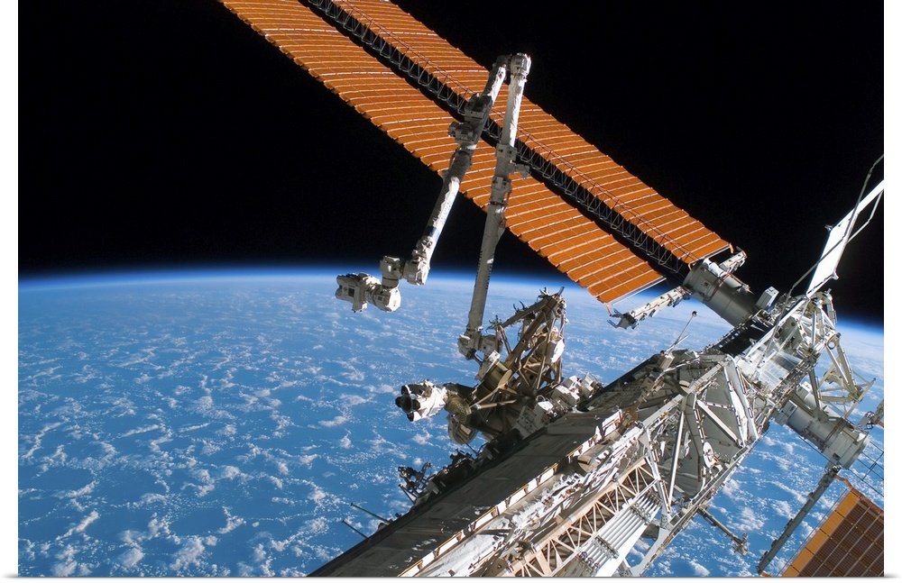 The Canadarm2 and solar array panel wings on the International Space Station