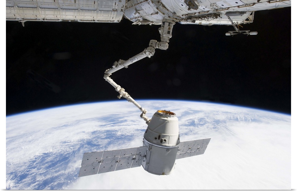March 3, 2013 - The docking of SpaceX Dragon to the International Space Station above a blue and white Earth.