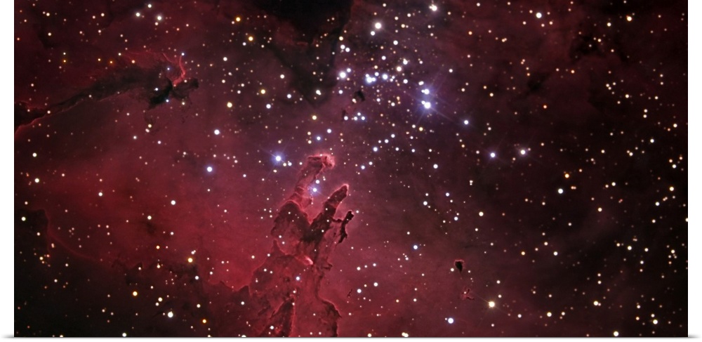 An oversized piece of the eagle nebula that has bright stars scattered across the print with a reddish purple hue.