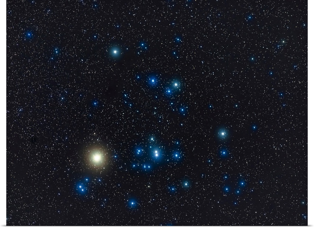 The Hyades star cluster with the red giant star Aldebaran (looking yellow here) in Taurus the bull in the winter sky.