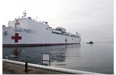 The Military Sealift Command hospital ship USNS Comfort pulls away from Canton Pier