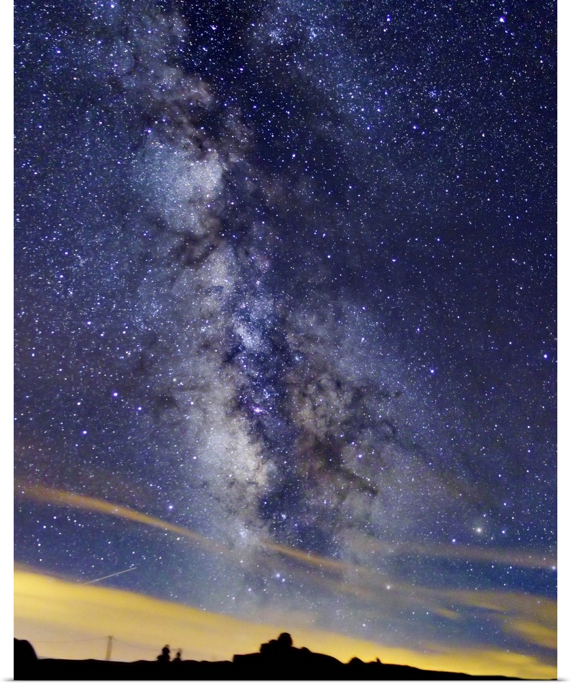 Big portrait photograph of the milky way swirling through the night sky in Serra da Esrela, Portugal.