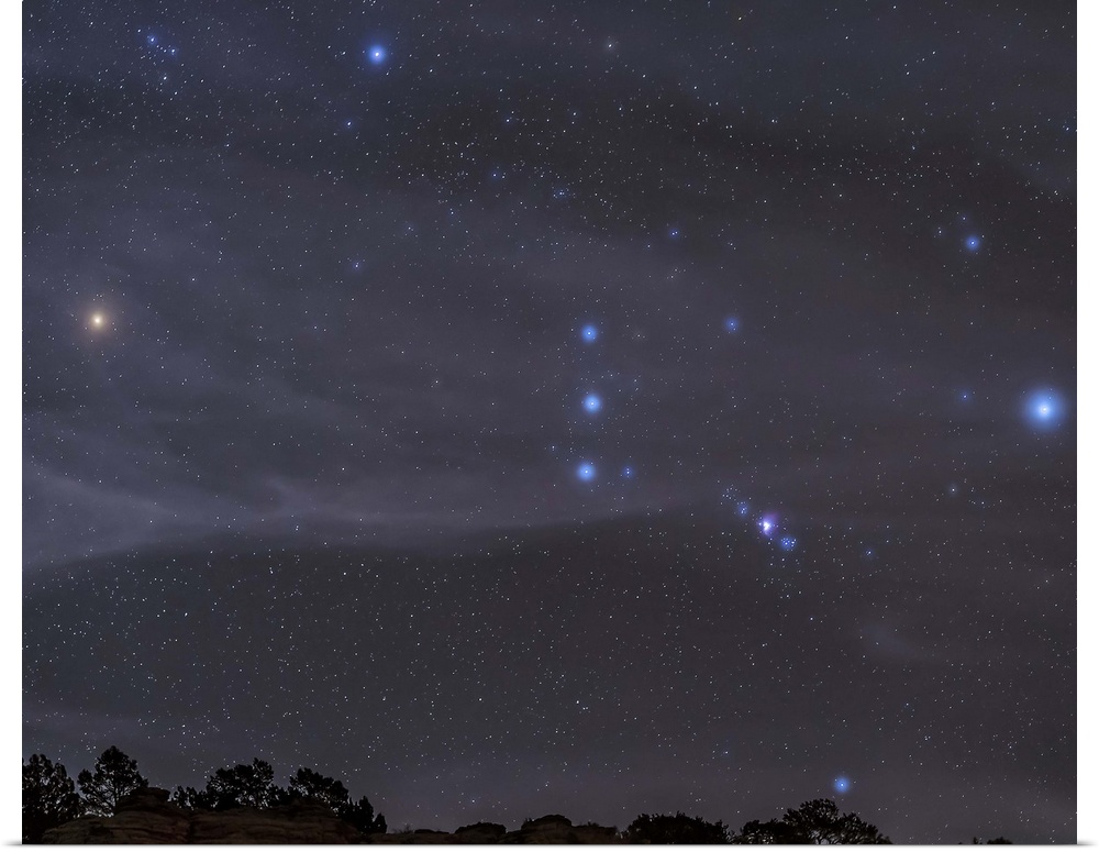 The Orion constellation rises over a hill through high thin clouds near Black Mesa, Oklahoma.