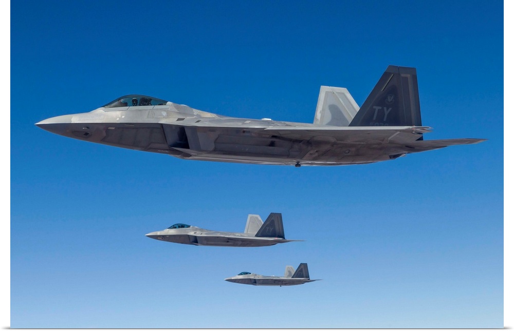 Three U.S. Air Force F-22 Raptors cruise above Nevada.