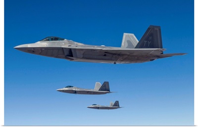 Three U.S. Air Force F-22 Raptors cruise above Nevada