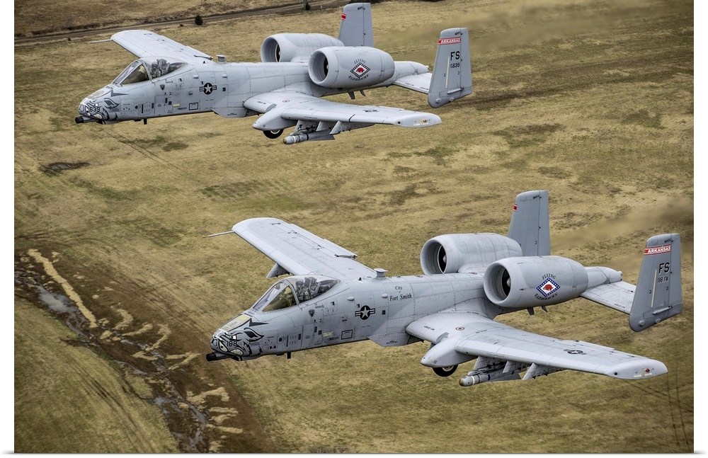 December 30, 2013 - Two A-10 Thunderbolt II's conduct a training mission over Razorback Range at Fort Chaffee Maneuver Tra...