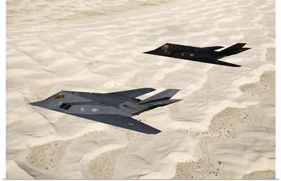 Two F-117 Nighthawk stealth fighters fly over White Sands National Monument