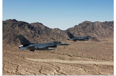 Two F-16s fly in formation over the Arizona desert