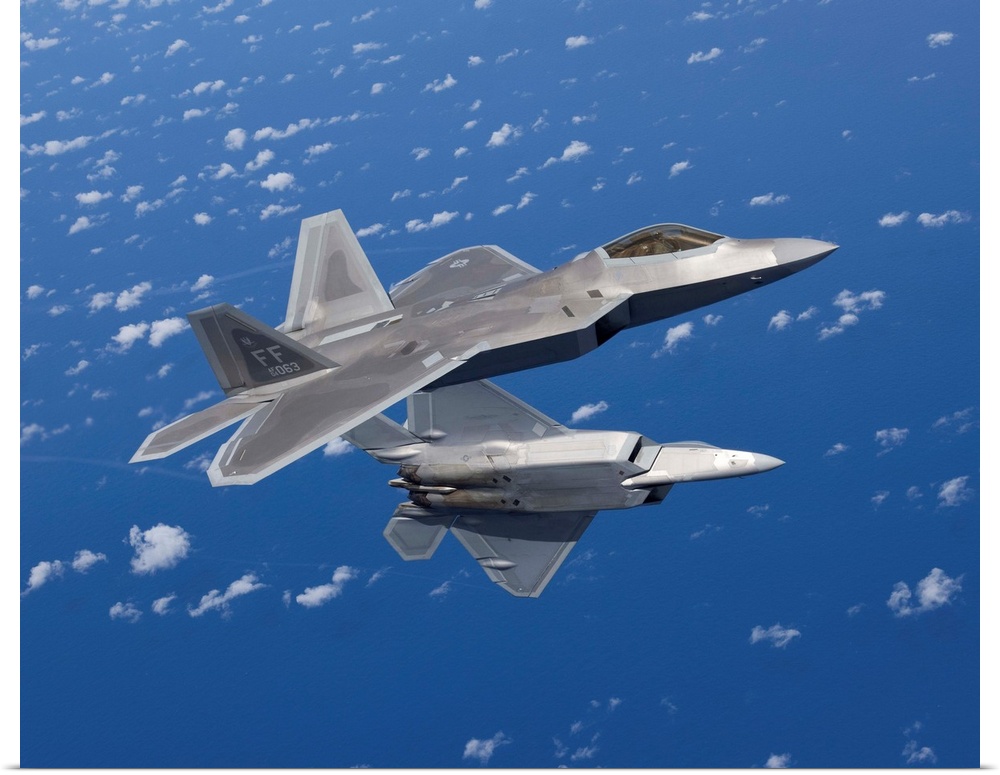 Two F-22 Raptors from the 1st Fighter Wing at Langley Air Force Base, Virginia, maneuver while flying a training mission o...