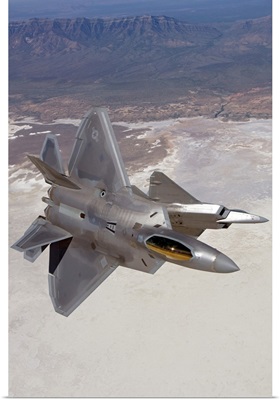 Two F-22 Raptors maneuver while on a training mission over New Mexico