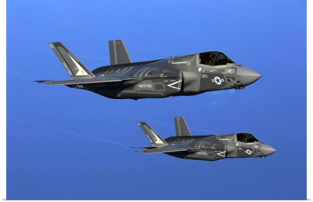 Two F-35B joint strike fighter jets conduct aerial maneuvers.