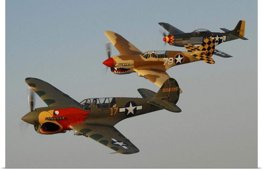 Two P-40 Warhawks and a P-51D Mustang flying over Chino, California.