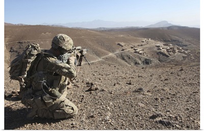 U.S. Army soldier provides security for infantry patrolling through Dandarh village