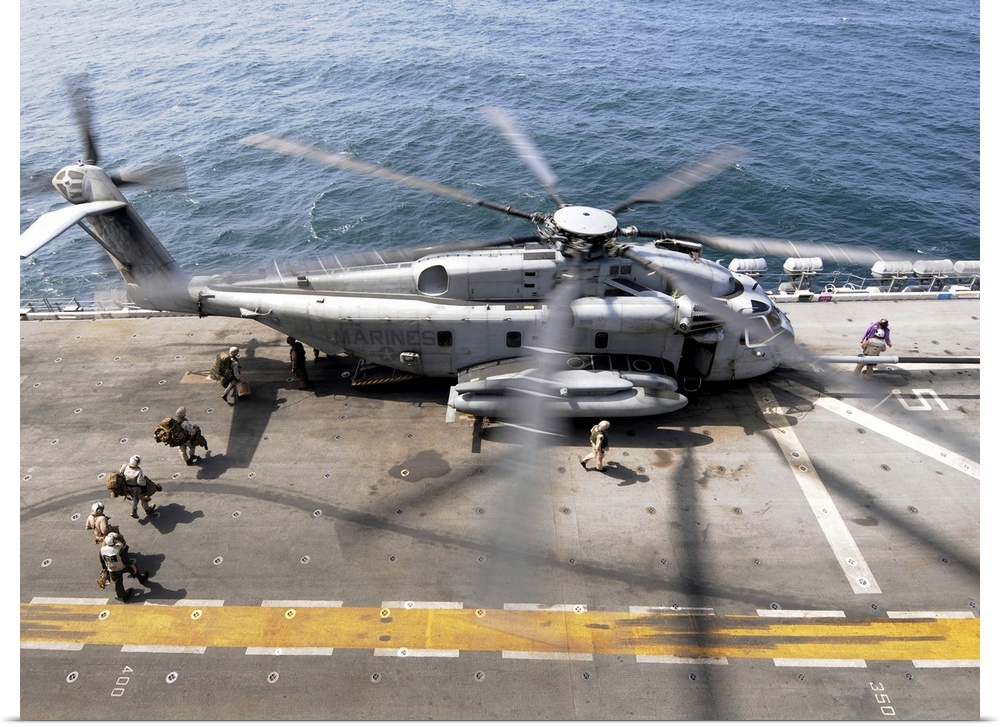 August 12, 2010 - U.S. Marines board an MH-53E Sea Dragon helicopter aboard the USS Peleliu while underway in the North Ar...