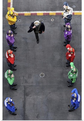 U.S. Navy rainbow sideboys stationed aboard aircraft carrier USS Abraham Lincoln