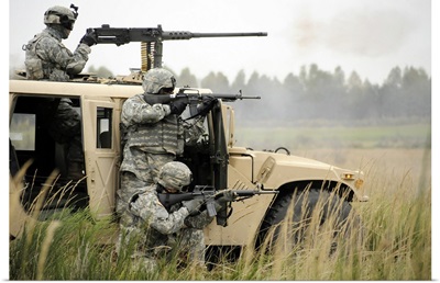 U.S. Soldiers perform a platoon mounted and dismounted live fire exercise