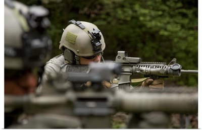 U.S. Special Forces soldiers provide security with automatic rifles