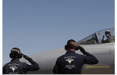 US Air Force Airmen salute the Captain of an aircraft