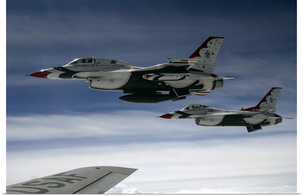 U.S. Air Force F-16 aircraft fly off the wing of a KC-135 Stratotanker.