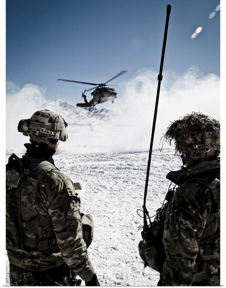 U.S. Army soldiers watch the arrival of a helicopter at their remote combat outpost in Marzak, Afghanistan. Marzak has bee...
