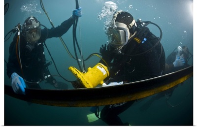 US Navy Diver Instructs A Barbados Coast Guard Diver On Using A Hydraulic Grinder