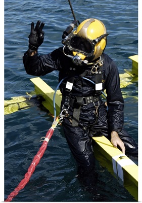 US Navy Diver Signals An OK Sign To The Dive Supervisor
