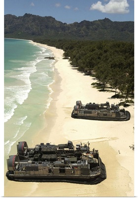 US Navy Landing Craft land on the beach to offload equipment in Oahu Hawaii