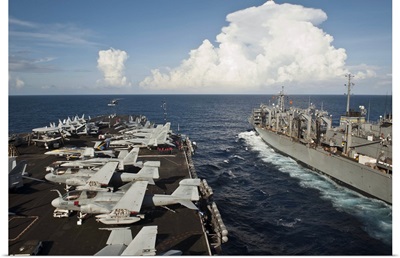 USS Nimitz and USNS Rainer transit alongside each other