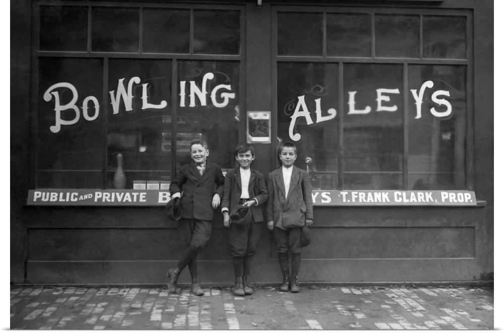 Vintage photo of a row of young boys posing in front of the Les Miserables bowling alley in Lowell, Massachusetts where th...