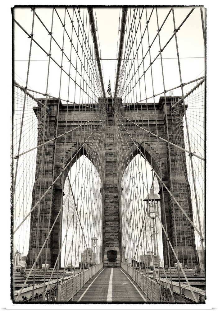 Black and white photograph of a dramatic view of the Brooklyn Bridge.
