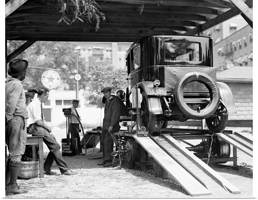 A car being inspected at an American gas station, 1924.