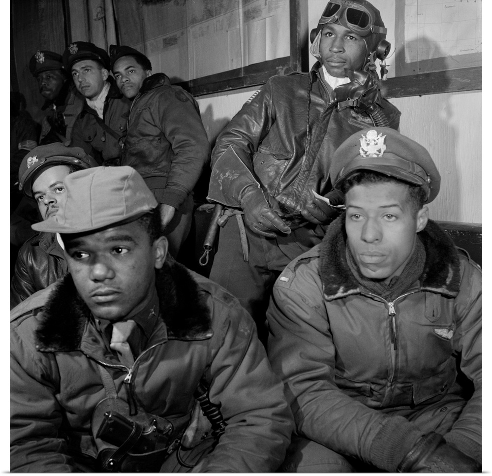 A group of Tuskegee Airmen attending a briefing at Ramitella Airfield in Italy, March 1945. Left to right: Joseph Chinewor...